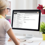 Image of a woman checking email on her desktop computer