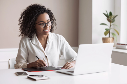 African American woman using laptop in home office.